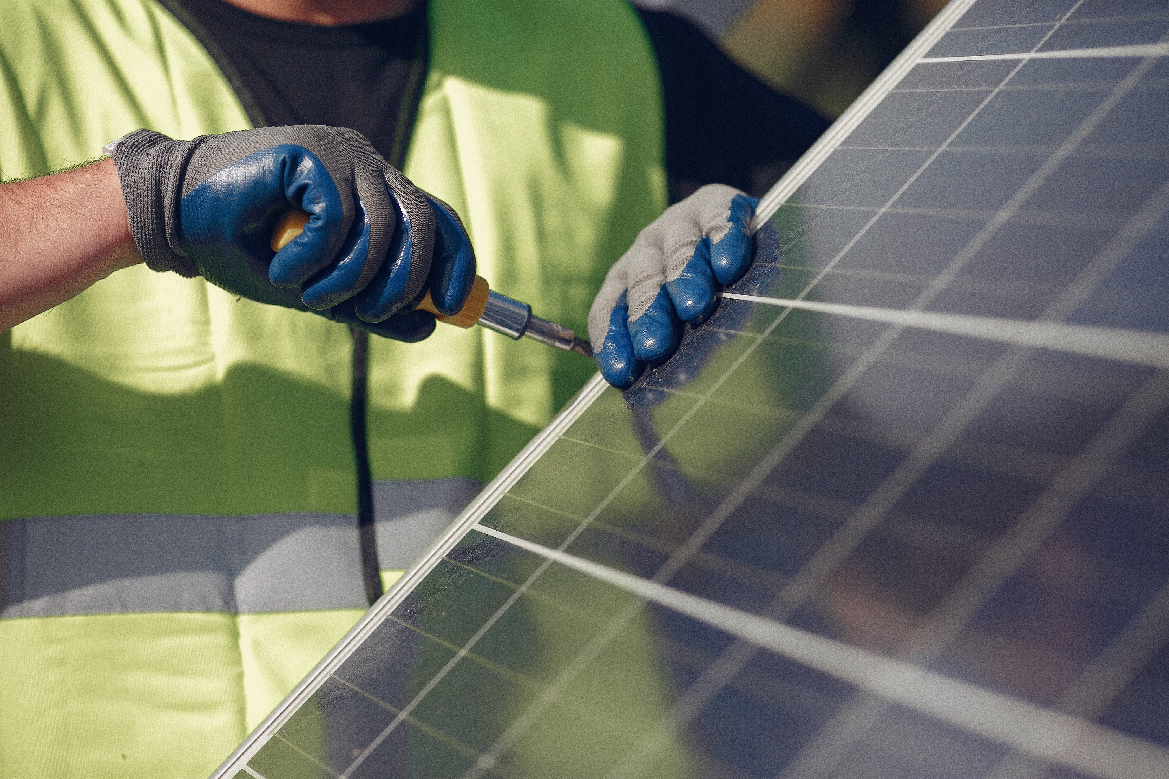 Installer fitting solar panels on a roof